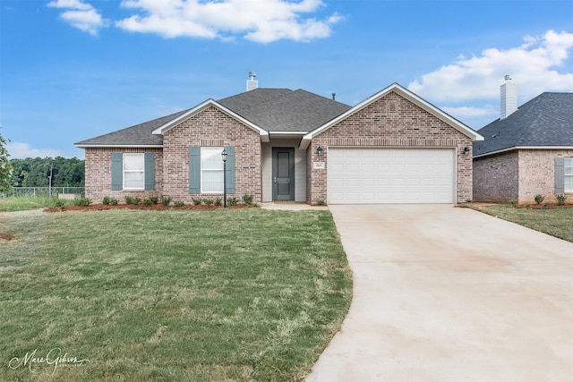 view of front of property with a front yard and a garage