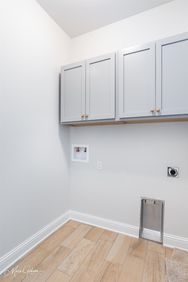 laundry area with light wood-type flooring, cabinets, hookup for an electric dryer, and hookup for a washing machine