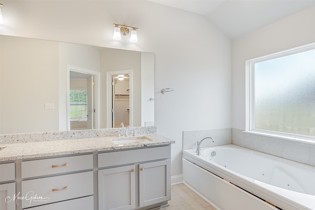 bathroom featuring tile patterned floors, vanity, and lofted ceiling