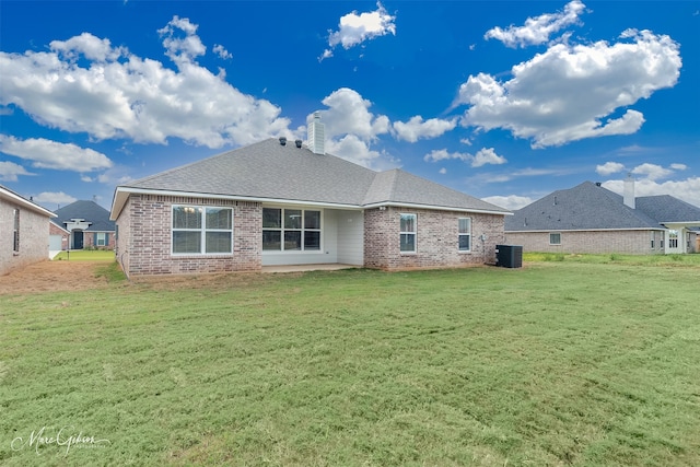 back of house with central AC, a patio area, and a yard