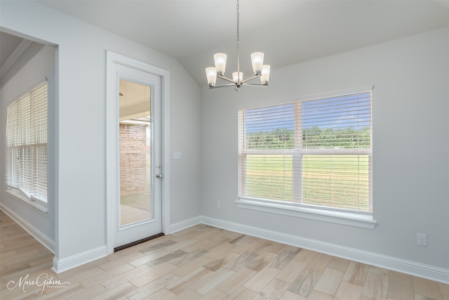 unfurnished dining area featuring a notable chandelier and light hardwood / wood-style floors