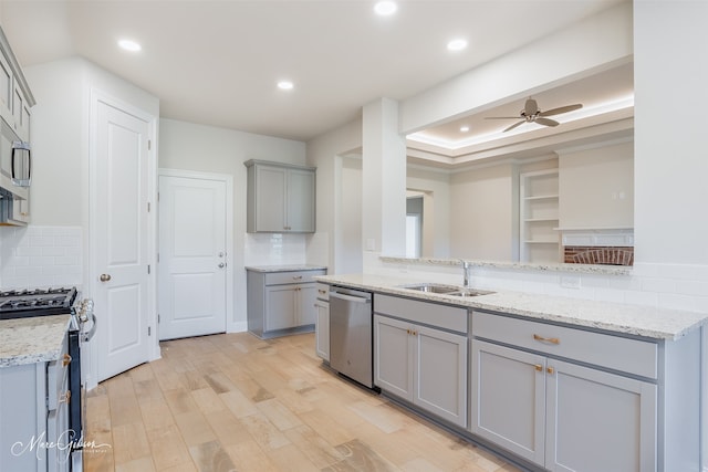 kitchen featuring ceiling fan, backsplash, range with gas cooktop, and dishwasher