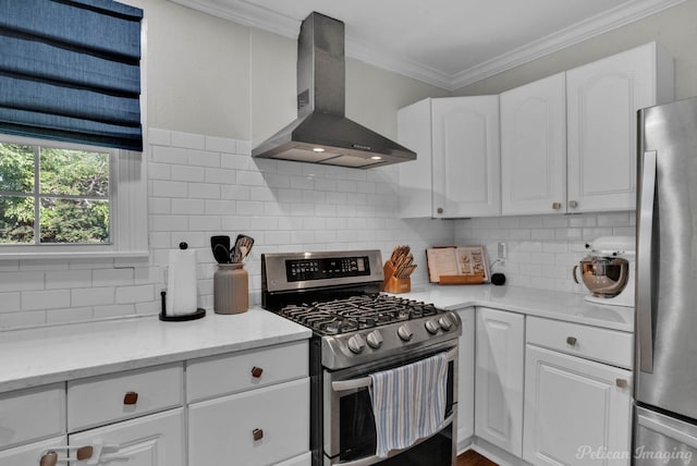 kitchen with stainless steel appliances, tasteful backsplash, white cabinetry, light stone counters, and wall chimney exhaust hood