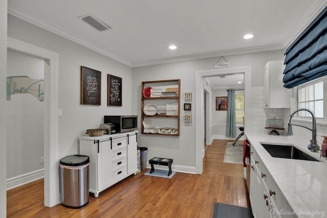 kitchen with backsplash, white cabinets, and a healthy amount of sunlight