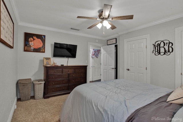 carpeted bedroom featuring crown molding and ceiling fan