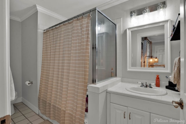 bathroom with crown molding, vanity, tile patterned flooring, and toilet