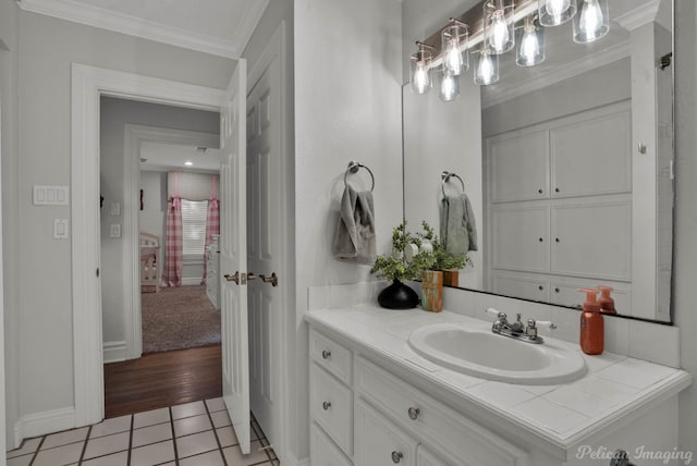 bathroom with vanity, hardwood / wood-style flooring, and crown molding