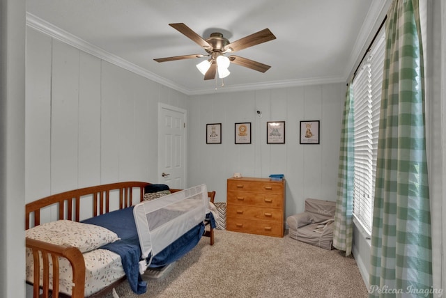 bedroom featuring ceiling fan, crown molding, multiple windows, and carpet floors