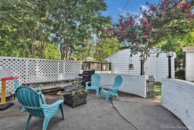 view of patio / terrace featuring grilling area and a fire pit