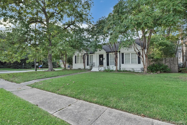 single story home featuring a front lawn