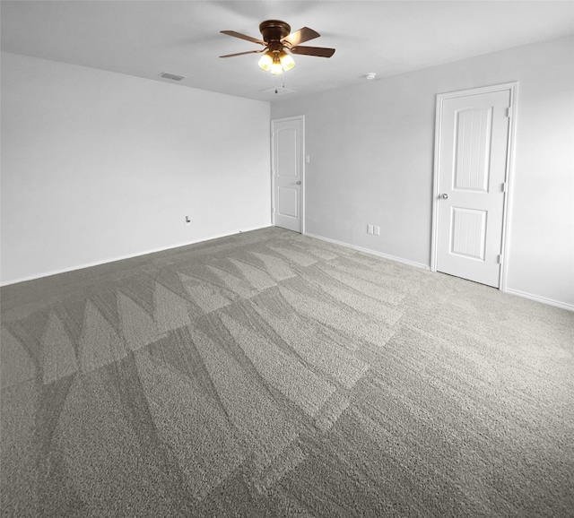 unfurnished room featuring ceiling fan and carpet floors