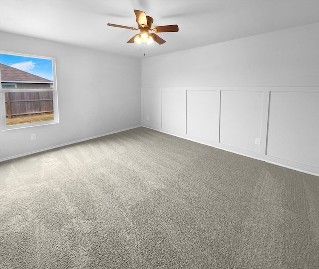 unfurnished room with ceiling fan and carpet floors