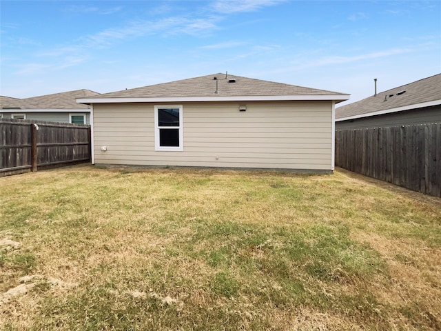 back of house featuring a lawn