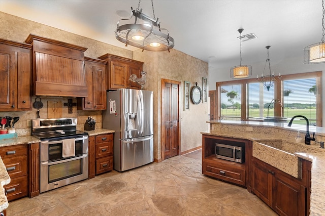 kitchen featuring hanging light fixtures, appliances with stainless steel finishes, light tile patterned flooring, sink, and tasteful backsplash