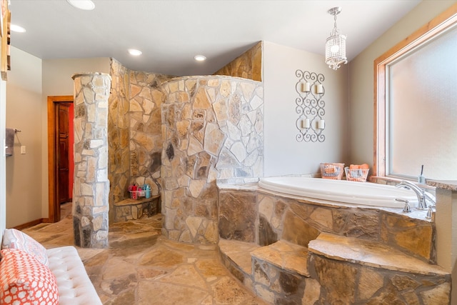 bathroom with tile patterned floors and a relaxing tiled tub