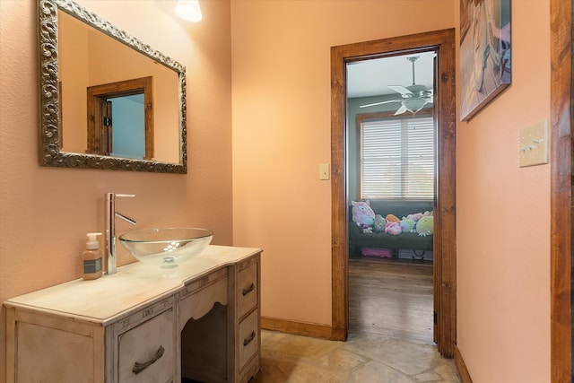 bathroom with ceiling fan, hardwood / wood-style flooring, and vanity