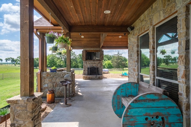 view of patio with an outdoor stone fireplace