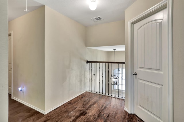 corridor featuring dark hardwood / wood-style flooring