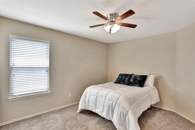 bedroom with ceiling fan and light carpet