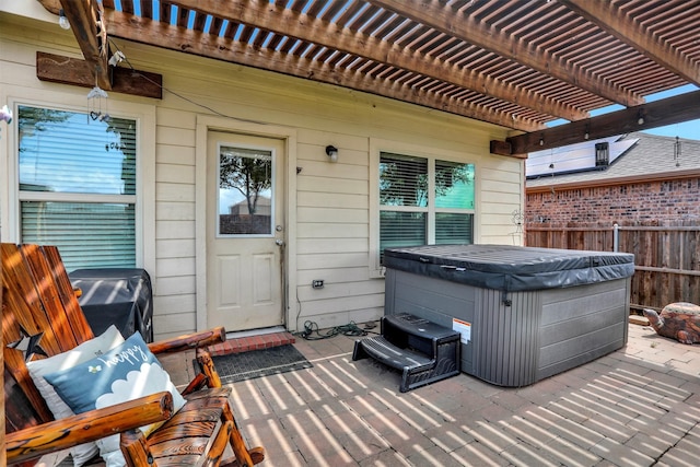 view of patio / terrace with a pergola and a hot tub