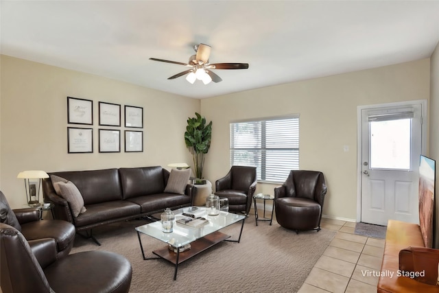 living room featuring ceiling fan, light tile patterned floors, and plenty of natural light