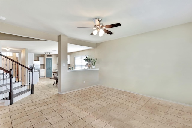 empty room featuring ceiling fan and light tile patterned floors