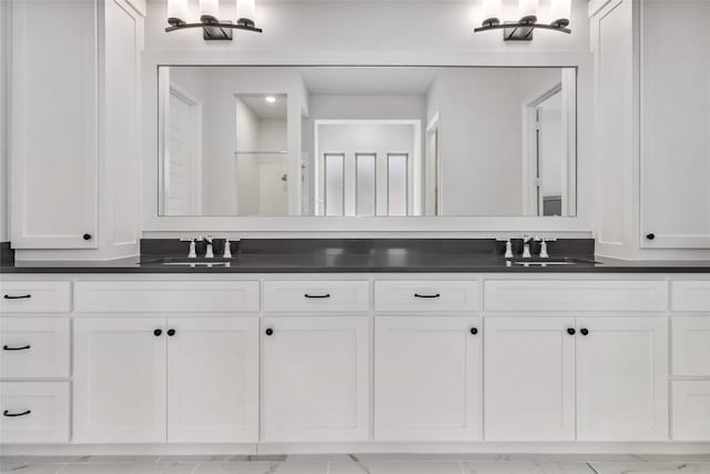 bathroom with walk in shower and vanity