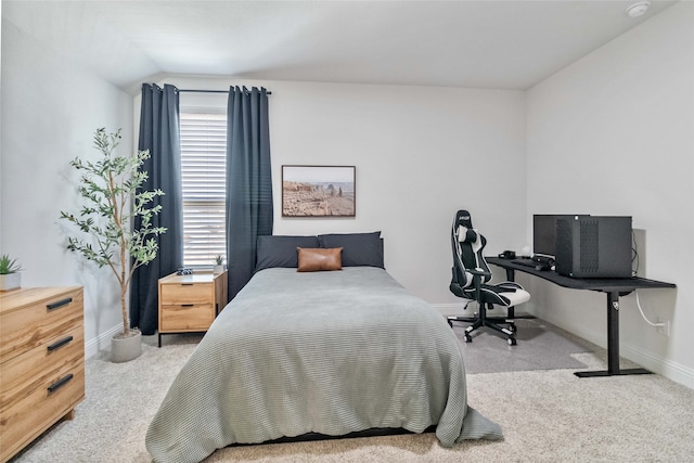 carpeted bedroom with lofted ceiling