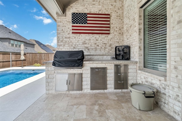 view of patio / terrace with a fenced in pool and a grill