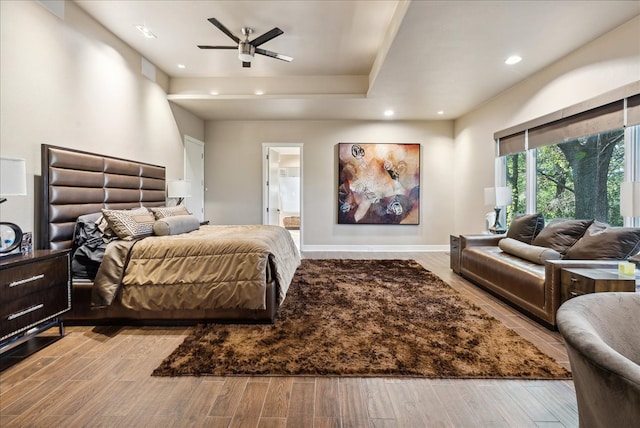 bedroom featuring ensuite bath, ceiling fan, and light hardwood / wood-style flooring