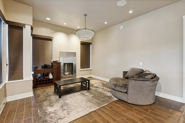 living room featuring dark hardwood / wood-style floors and a chandelier