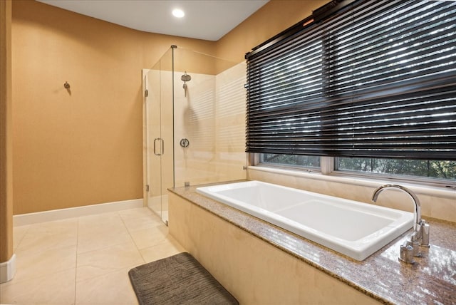 bathroom featuring shower with separate bathtub and tile patterned flooring