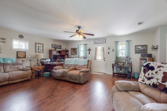 living room with ceiling fan and dark hardwood / wood-style flooring