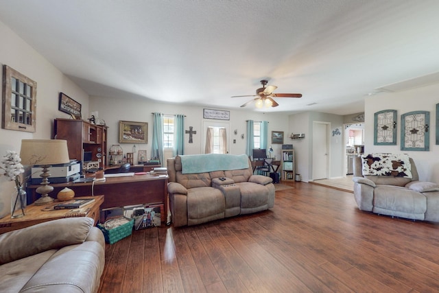 living room featuring dark hardwood / wood-style flooring and ceiling fan