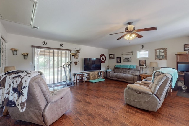 living room featuring ceiling fan and dark wood-type flooring