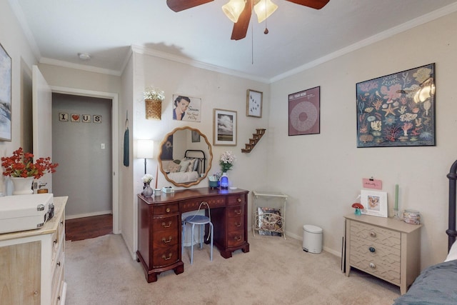 carpeted office space with ceiling fan and ornamental molding