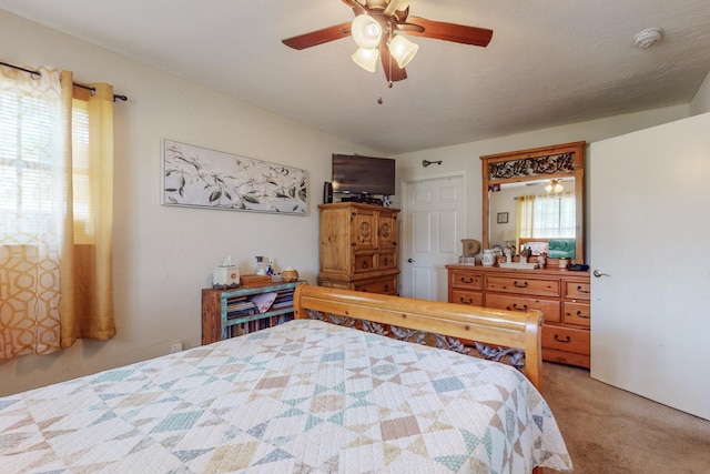 bedroom featuring light carpet and ceiling fan