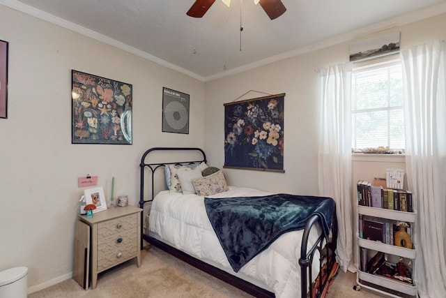 carpeted bedroom with ceiling fan and ornamental molding