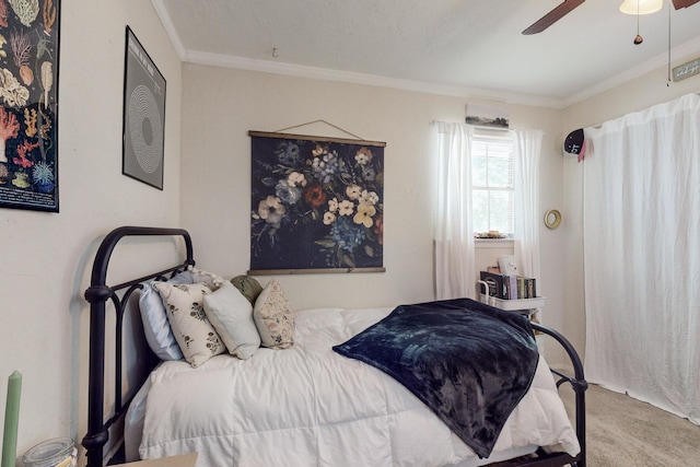 carpeted bedroom featuring crown molding and ceiling fan