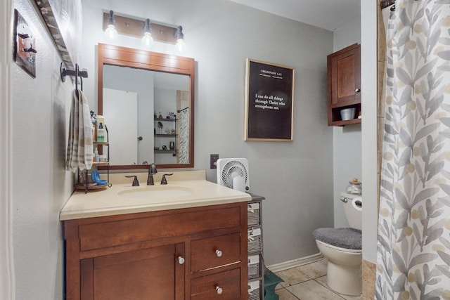 bathroom with vanity, tile patterned flooring, toilet, and walk in shower