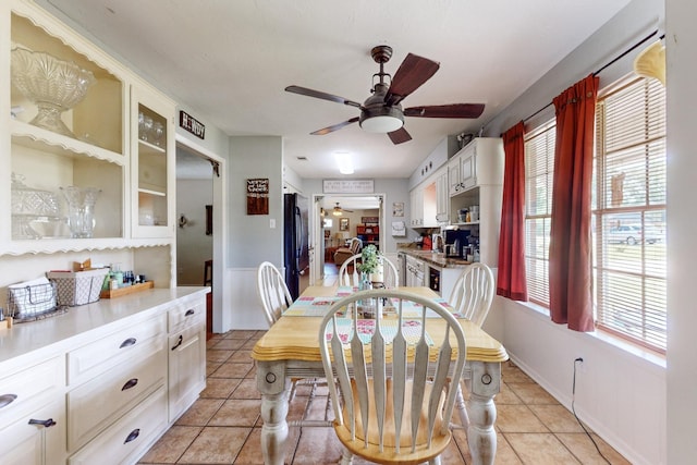 dining space with light tile patterned flooring and ceiling fan