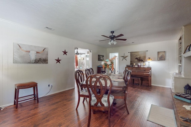 dining room with dark hardwood / wood-style flooring, ceiling fan, and a textured ceiling