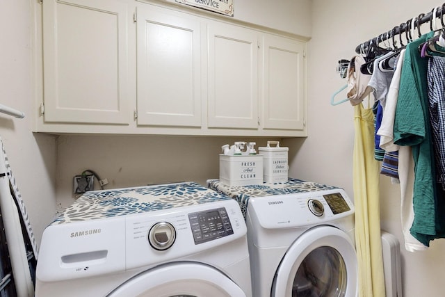 laundry area with cabinets and washer and clothes dryer