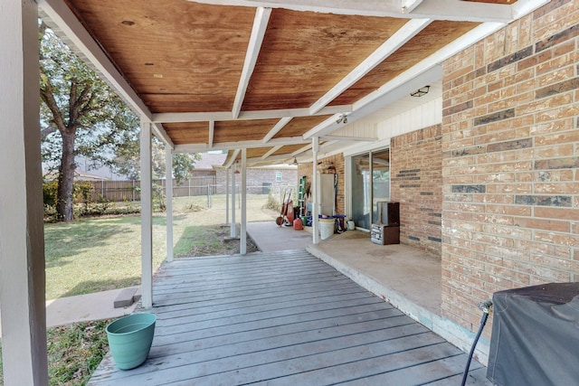 wooden terrace with area for grilling and a lawn