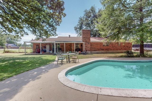 view of pool featuring a patio area and a lawn