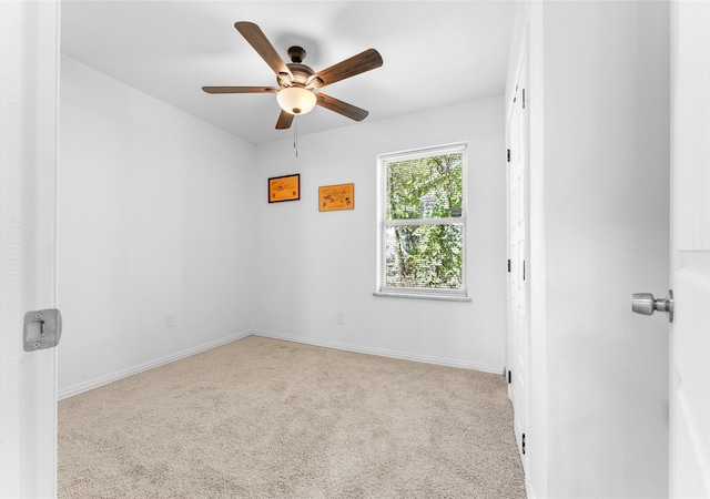 empty room with light colored carpet and ceiling fan