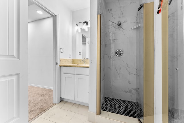 bathroom featuring vanity and tiled shower