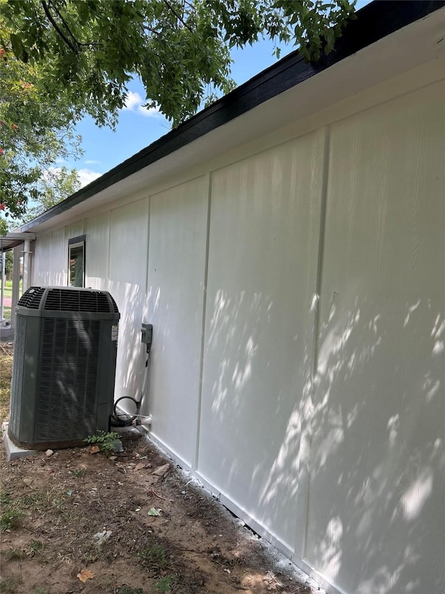 view of side of property with central air condition unit