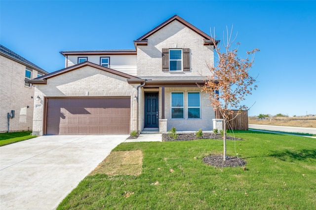 view of front of property featuring a front yard and a garage