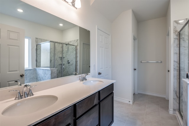 bathroom featuring tile patterned flooring, vanity, and a shower with door